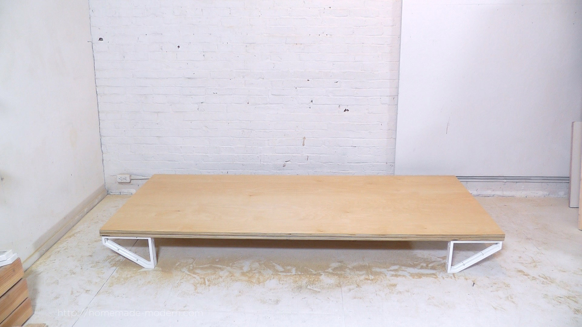 This DIY Modern Bed is made from a sheet of ¾” plywood, and 10 ikea shelf brackets. The materials cost  less than $100 and only 3 power tools are needed to build it. Full instructions can be found at HomeMade-Modern.com.