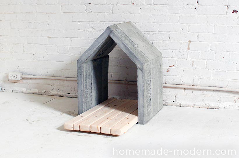 This modern concrete doghouse is made out of Quikrete Countertop Mix poured into a mold made out of 2x4s and Masonite. I poured the concrete in layers so that the weight of the wet concrete would not push the thin Masonite out. For full instructions go to HomeMade-Modern.com.